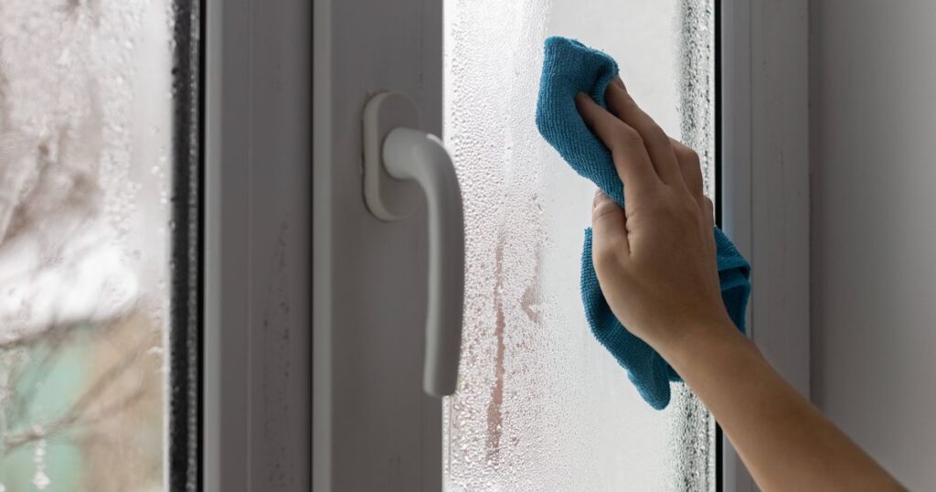 0_A-womans-hand-wipes-the-condensate-from-the-window-glass.jpg