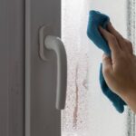 0_A-womans-hand-wipes-the-condensate-from-the-window-glass.jpg