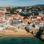 0_Drone-aerial-view-of-unidentifiable-sunbathers-at-Praia-da-Rainha-beach-in-Cascais-Portugal.jpg