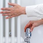 0_Female-hands-adjusting-a-heating-temperature-on-a-radiator-at-home.jpg
