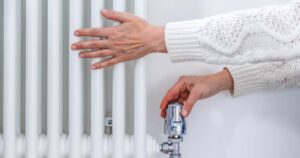 0_Female-hands-adjusting-a-heating-temperature-on-a-radiator-at-home.jpg