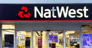 0_Modern-NatWest-bank-exterior-with-illuminated-logo-and-glass-entrance-at-night.jpg