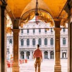 0_Rear-view-of-a-man-standing-in-the-arch-looking-at-Piazza-San-Marco-square-in-Venice-Italy.jpg