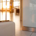 0_Suitcase-standing-in-airport-terminal-at-sunset-ready-for-vacation.jpg