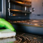 0_Woman-using-sponge-to-clean-modern-oven-in-a-stylish-kitchen.jpg