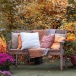 0_Wooden-garden-bench-with-pillows-among-autumn-flowers-and-colorful-foliage-in-yellow-fall-backyard.jpeg