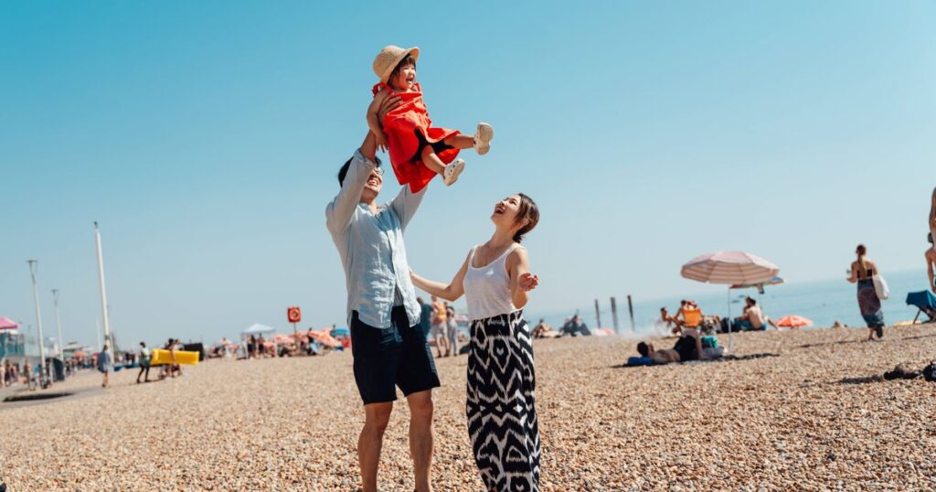 0_Young-Asian-family-having-fun-on-the-beach.jpg