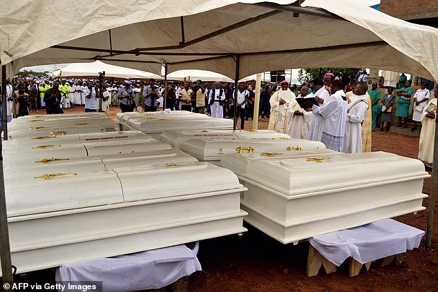 103892237-15291917-Coffins_of_17_worshippers_and_two_priests_who_were_allegedly_kil-a-6_176330659690.avif