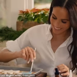104018391-15307751-Meghan_smiling_while_painting_snowflake_cookies_for_Archie_and_L-a-46_17635926148.avif
