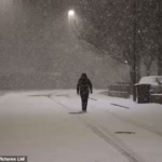 104034905-15311285-A_person_walks_in_the_snow_in_Newcastle_early_this_morning_amid_-a-2_176367544253.avif