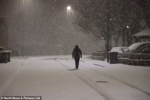 104034905-15311285-A_person_walks_in_the_snow_in_Newcastle_early_this_morning_amid_-a-2_176367544253.avif