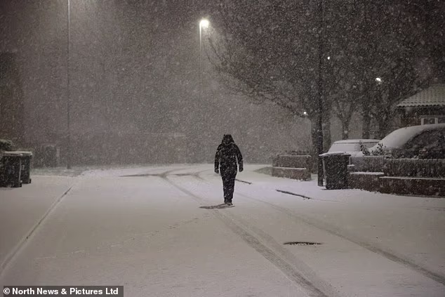 104034905-15311285-A_person_walks_in_the_snow_in_Newcastle_early_this_morning_amid_-a-2_176367544253.avif