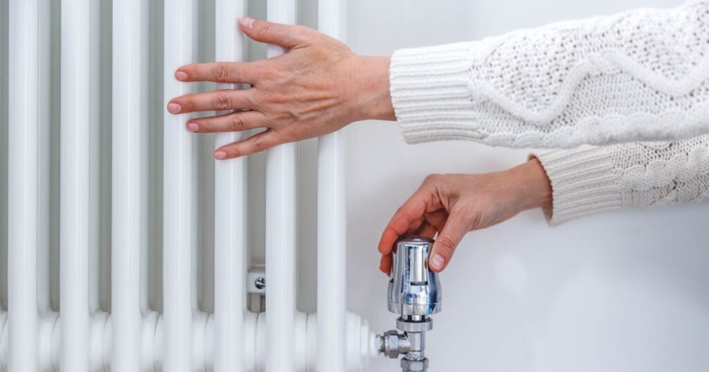 1763617504_0_Female-hands-adjusting-a-heating-temperature-on-a-radiator-at-home.jpg