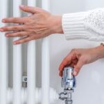 1763617504_0_Female-hands-adjusting-a-heating-temperature-on-a-radiator-at-home.jpg