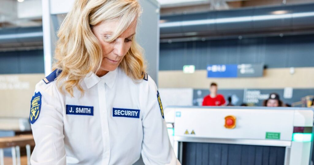1_Adult-Caucasian-Female-Airport-Security-Guard-Checking-The-X-Ray-Machine.jpg