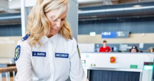 1_Adult-Caucasian-Female-Airport-Security-Guard-Checking-The-X-Ray-Machine.jpg