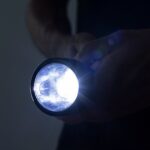 1_Unrecognizable-male-holding-a-flashlight.jpg