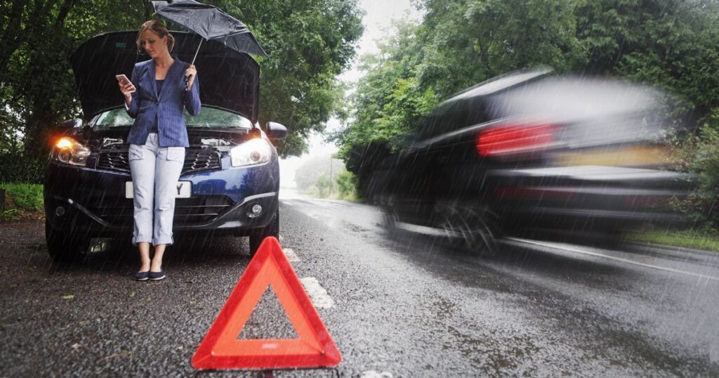 1_Woman-on-side-of-road-with-broken-down-car-in-the-rain.jpg