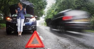 1_Woman-on-side-of-road-with-broken-down-car-in-the-rain.jpg