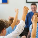 2_Excited-School-Children-in-Uniform-with-Hands-Up.jpg