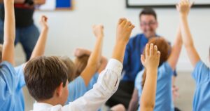 2_Excited-School-Children-in-Uniform-with-Hands-Up.jpg