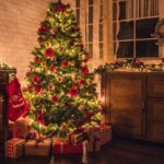 decorated-christmas-tree-near-fireplace-1039166812.jpg