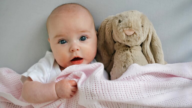 portrait-baby-bed-cuddling-soft-1040777286.jpg