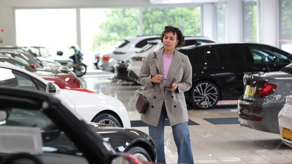 woman-looking-cars-showroom-1014462515.jpg