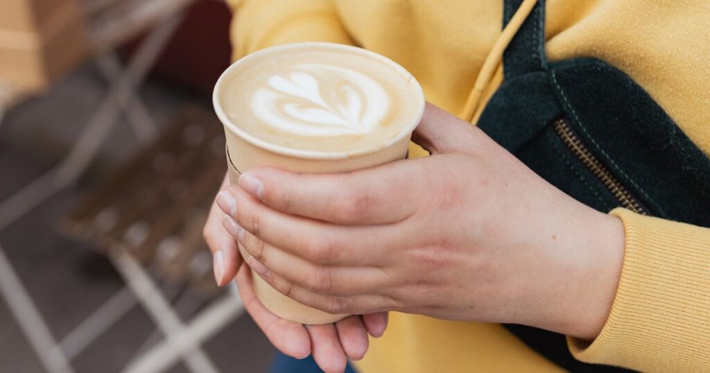 0_Bio-paper-cup-with-coffee-latte-art-in-woman-hand-Young-stylish-hipster-redhead-girl-drinking-hot.jpeg