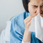 0_Close-up-of-Asian-female-patient-sneezing-in-tissue-cause-of-cold-and-flu-while-admitted-at-hospit.jpeg