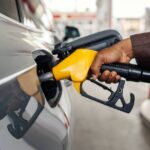 0_Close-up-of-interracial-mans-hand-holding-nozzle-and-pouring-gasoline-at-gas-station.jpg