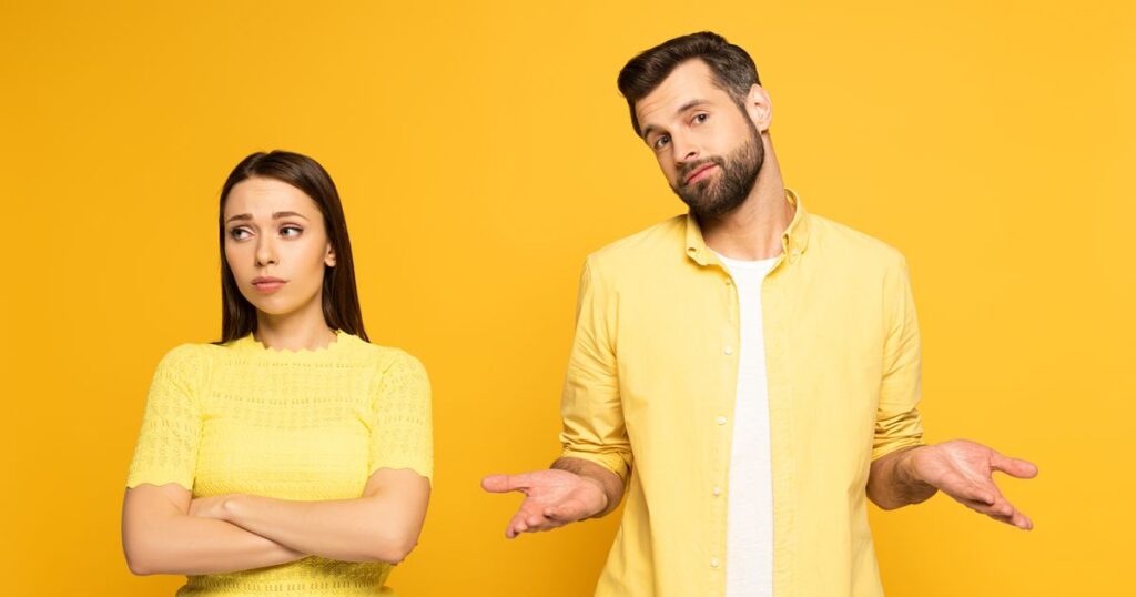 0_Confused-man-standing-near-spherical-girlfriend-on-yellow-background.jpg