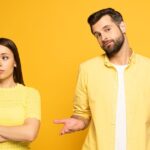 0_Confused-man-standing-near-spherical-girlfriend-on-yellow-background.jpg
