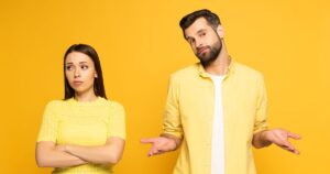 0_Confused-man-standing-near-spherical-girlfriend-on-yellow-background.jpg