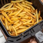 0_HAND-HOLDING-AIR-FRYER-BASKET-WITH-FRESHLY-MADE-FRENCH-FRIES-OR-FRIED-POTATOES-IN-THE-KITCHEN-TOP.jpeg