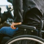 0_Midsection-of-woman-on-wheelchair-by-car.jpg