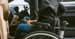 0_Midsection-of-woman-on-wheelchair-by-car.jpg