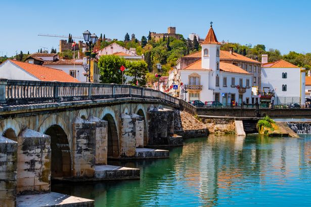 0_Old-bridge-Ponte-Vhela-over-Nabao-river-leading-to-the-historic-centre-of-Tomar-picturesque-vill.j.jpeg