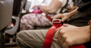 0_Plane-passenger-touching-their-seatbelt.jpg