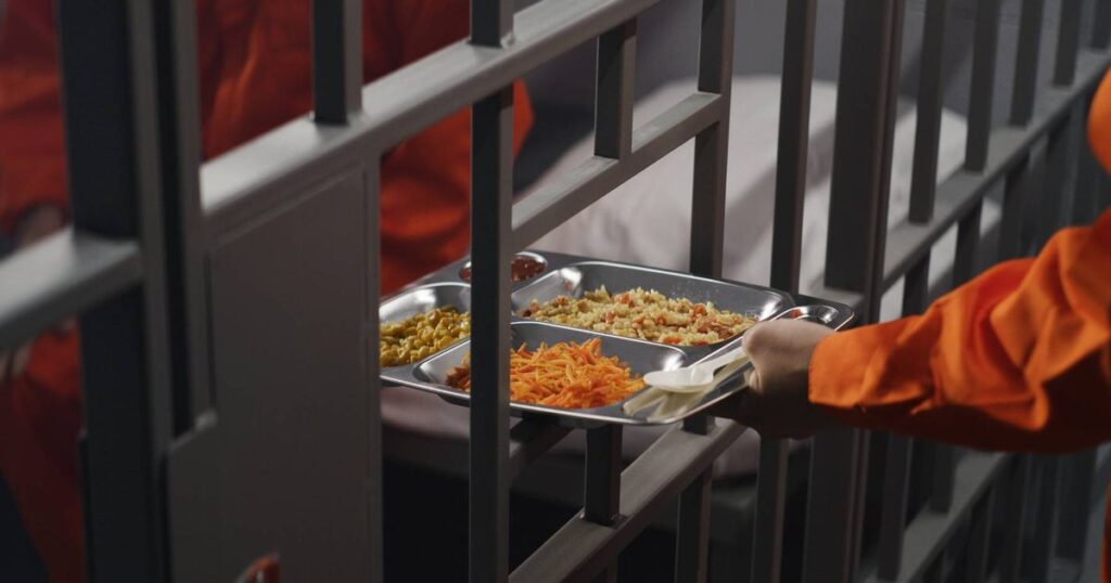 0_Prison-guard-gives-food-to-prisoner-through-metal-bars.jpg