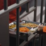 0_Prison-guard-gives-food-to-prisoner-through-metal-bars.jpg