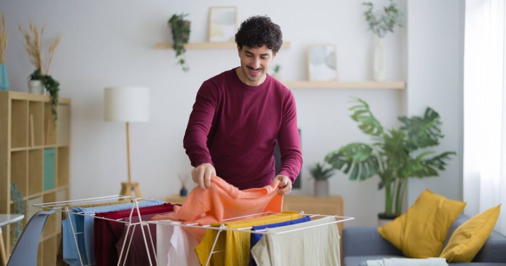 0_Smiling-man-hanging-clean-laundry-at-home.jpg