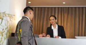 0_Traveller-Checking-In-at-a-Hotel-Reception-Desk-with-Friendly-Staff-Interaction.jpg