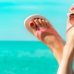 0_Upside-woman-feet-and-red-pedicure-wearing-pink-sandals-sunglasses-at-seaside-Funny-and-happy-fash.jpeg