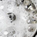 0_White-foam-with-bubbles-of-cleaner-in-a-washbasin-macro-view-Drain-hole-with-soap-bubbles-in-metal.jpeg