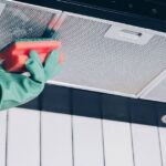 0_Womans-hand-removing-a-filter-from-cooker-hood-for-cleaning-or-service-Replacing-filter-in-kitchen.jpeg
