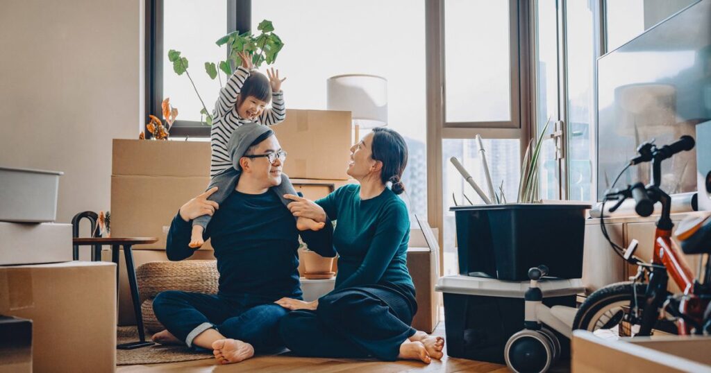 0_Young-Asian-family-sitting-on-the-floor-chatting-and-resting-while-unpacking-boxes-after-moving-in.jpeg