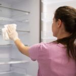 0_Young-woman-cleaning-fridge-in-hygiene-concept.jpg