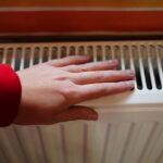 0_woman-hands-keeping-warm-by-a-heating-radiator-Close-up-unrecognizable-face.jpg