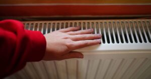0_woman-hands-keeping-warm-by-a-heating-radiator-Close-up-unrecognizable-face.jpg